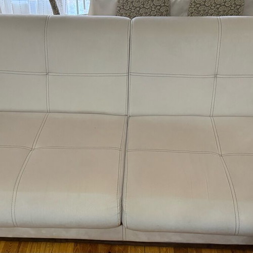 Three-seater sofas used with two stools and storage space