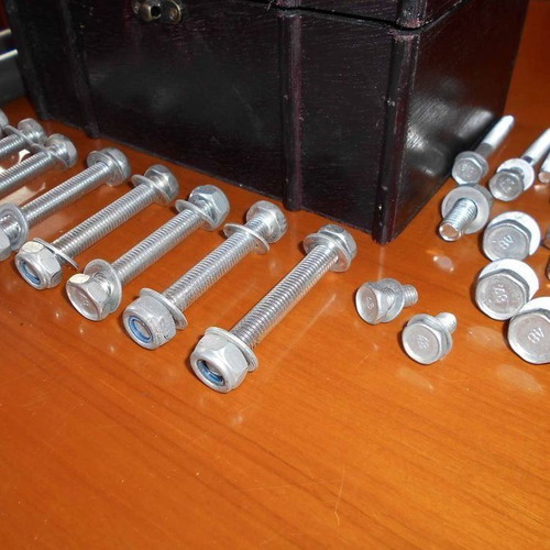 Box with various metal parts and 18 screws used