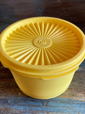 Tupperware vintage food storage container used, yellow with radial lid
