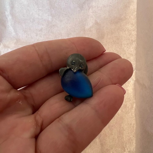 Silver penguin pin used with blue stone