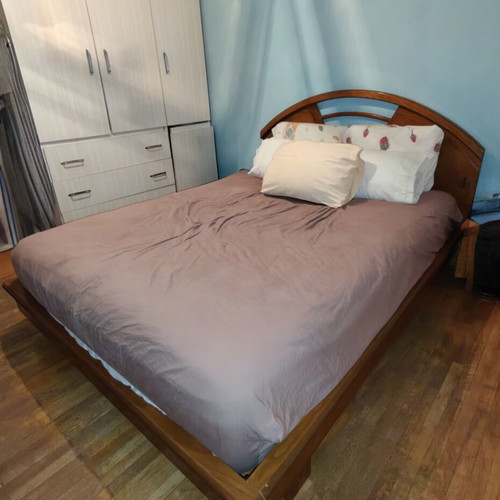 Wooden double bed frame with carved headboard, no mattress
