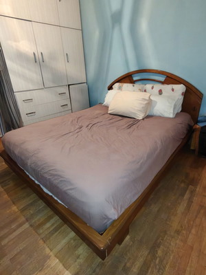 Wooden double bed frame with carved headboard, no mattress