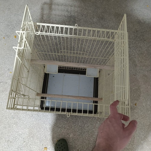 Large metal bird cage like new, with wooden perches and feeders