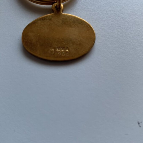 Vintage Metropolitan Museum of Art keychain with blue enamel and gold-plated peace bird pendant, like new