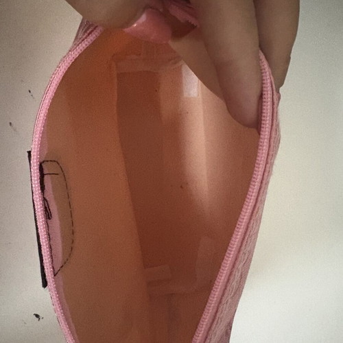 Pink toiletry bag like new with all-over logo pattern