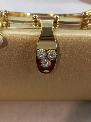 Gold evening handbag like new with missing rhinestone
