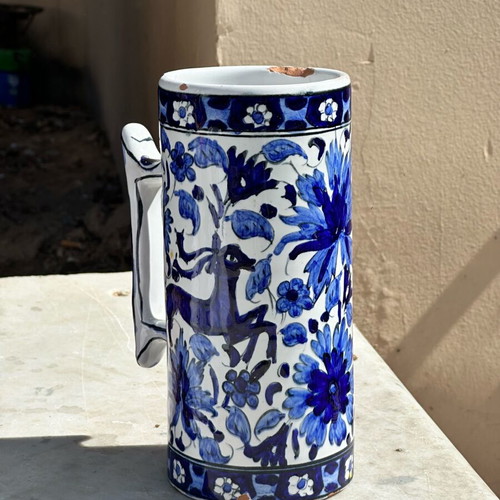 Vintage handmade ceramic cup and decorative Delft style jug used, blue floral