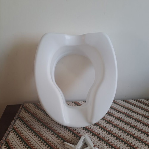 Toilet seat used, raised for adults