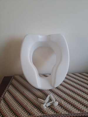 Toilet seat used, raised for adults