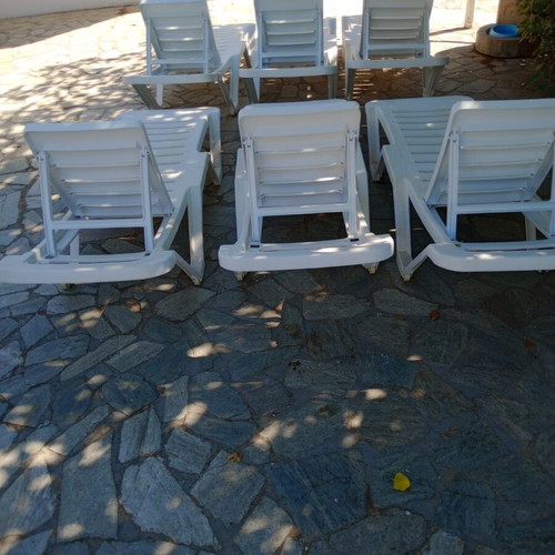 Plastic sun loungers with two wheels