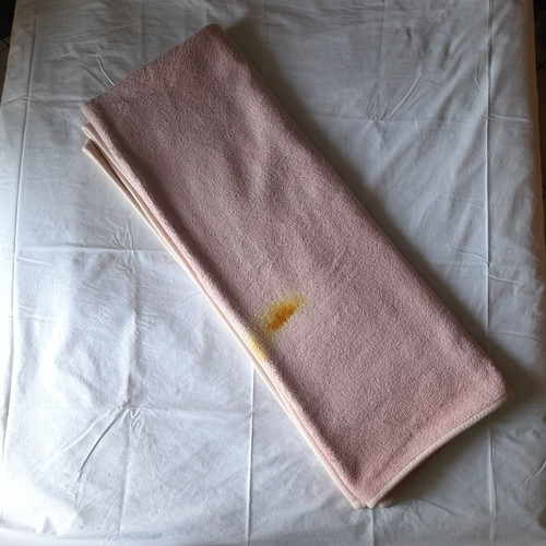 Single blanket used, pink with burn mark