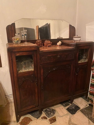 Antique buffet from interwar period 1930 with marble, mirror and handcrafted carvings used