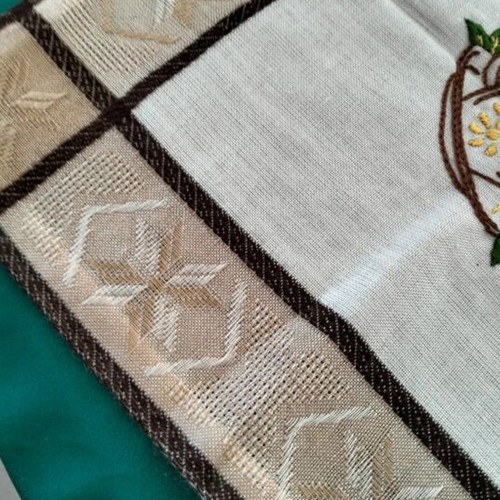 Embroidered square table linen with coffee cup and floral design