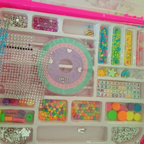 Bracelet making set used with beads and tools, includes Lego bracelet