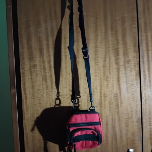 Small red shoulder bag used with multiple compartments