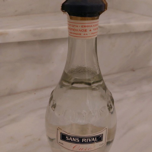 Ouzo Sans Rival 1lt new in round bottle, sealed, collectible