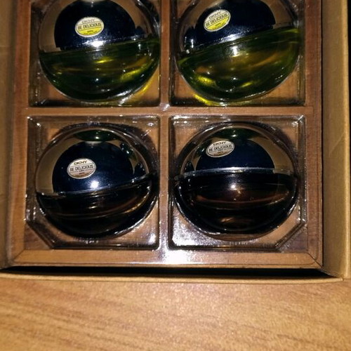 DKNY collectible empty Be Delicious miniatures used, set of 4 with wooden base