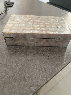 Box with glossy beige-white texture