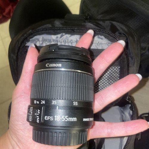 Canon EOS 1200D camera kit with lenses, memory card, battery, charger, and carrying bag