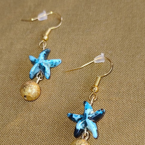 Handmade gold-tone earrings with blue starfish