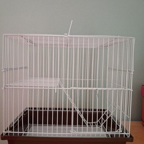 Hamster cage like new with two doors, house, feeder, and water bottle