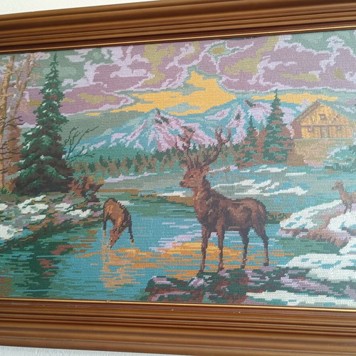 Handmade cross-stitch embroidery in wooden frame, used