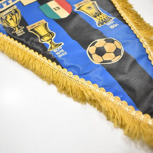 Inter collection with scarves, pennants, cufflinks, magazines and backpack