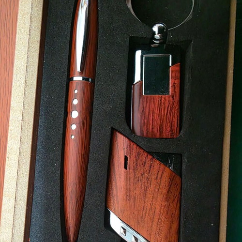 Set of three gifts in luxury wooden box with pen, lighter and keychain