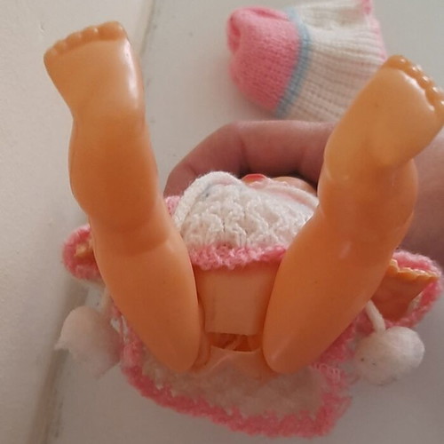 Vintage plastic baby doll from the 70s used with handmade sweater and hat