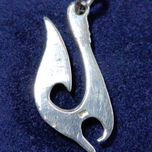 Silver Maori-inspired pendant in traditional hei matau style