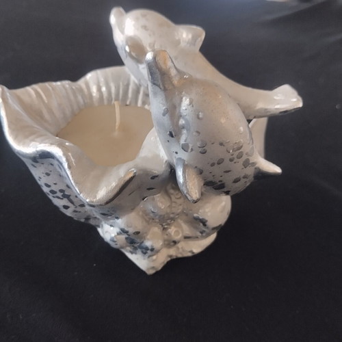 Decorative candle with dolphins used, vintage style