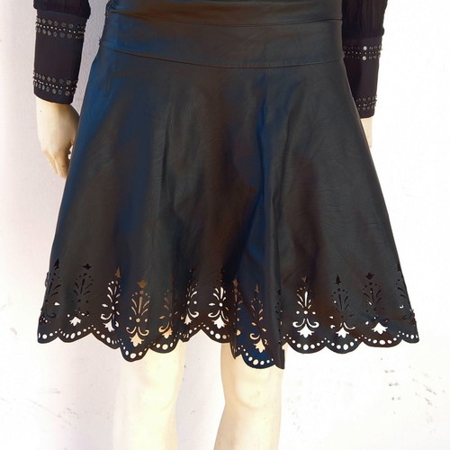 Laser cut skirt made of black faux leather used with handmade details