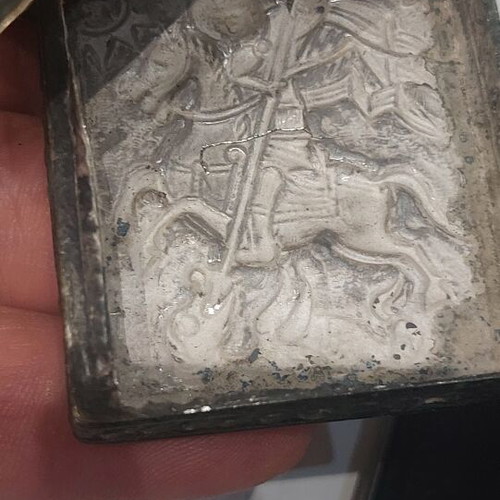 Old religious amulet with wear, needs repair