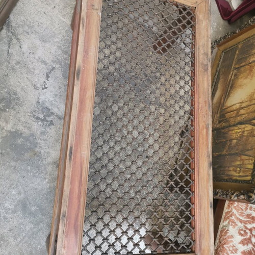 Vintage wooden coffee table used with industrial metal mesh design