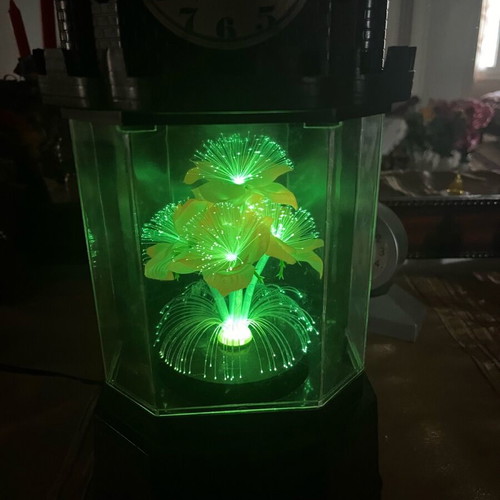 Table clock used collectible with lighting and rotating flower