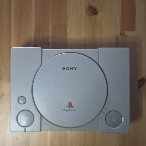 Sony PlayStation 1 console used with memory card, controller, and game