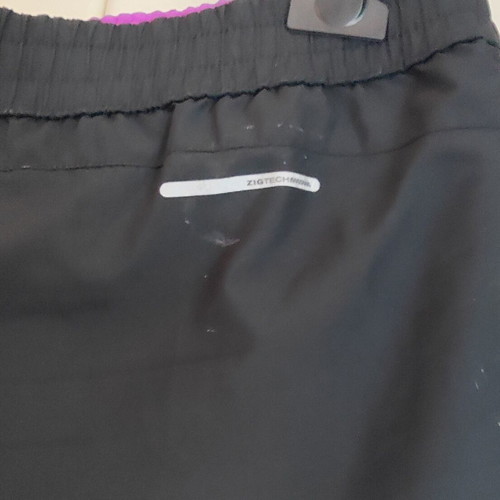 Reebok women's PlayDry ZigTech running shorts used, black and purple, size M