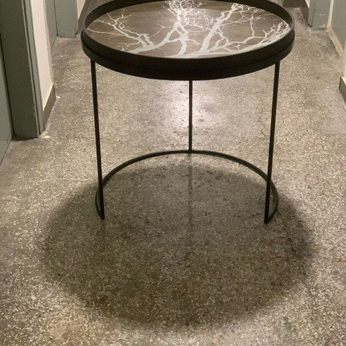 Decorative coffee table used with metal base and wooden top frame