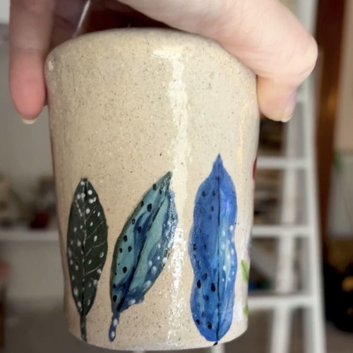 Illustrative ceramic mug handmade with floral design