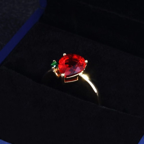 Adjustable ring with red teardrop stone and green detail, gold plated