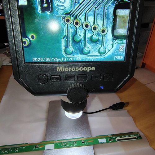 Digital bench microscope with adjustable height and built-in lighting