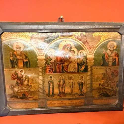 Old multi-themed religious icon on wood with glass used