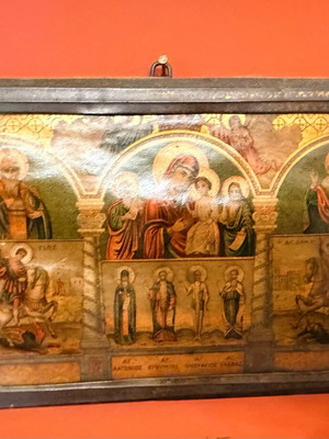 Old multi-themed religious icon on wood with glass used