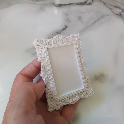 Vintage plaster frame with perfume bottle
