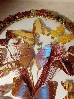 Vintage framed art with colorful stones and butterflies