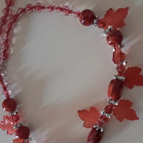 Handmade red necklace with beads and decorative leaves like new
