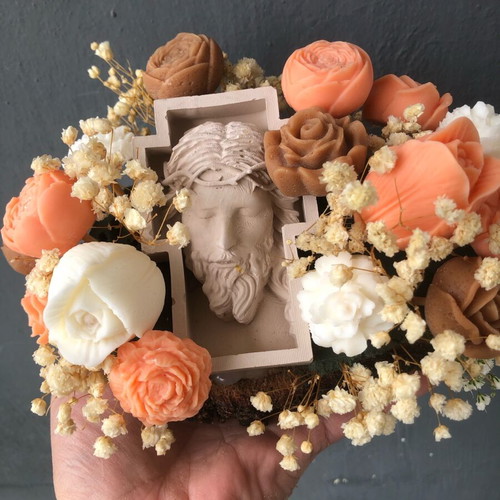 Handmade arrangement with scented candles and embossed Christ figure