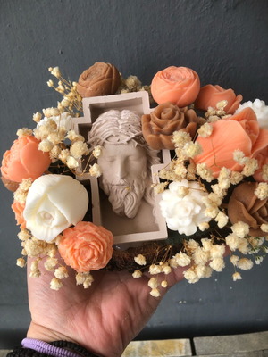 Handmade arrangement with scented candles and embossed Christ figure