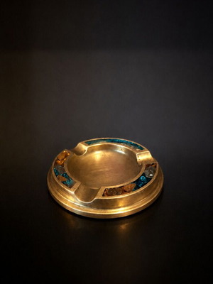 Vintage metal ashtray with mosaic design used