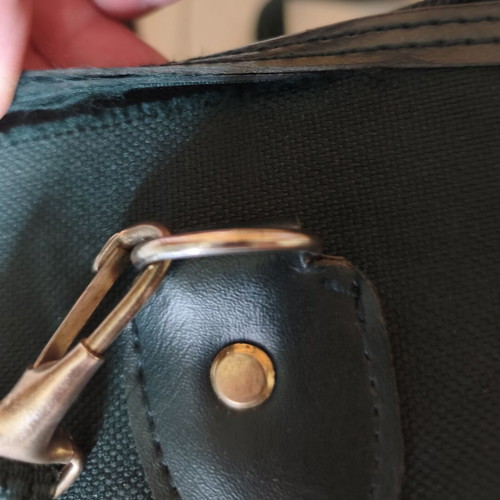 Toiletry bag used, green, fabric defect